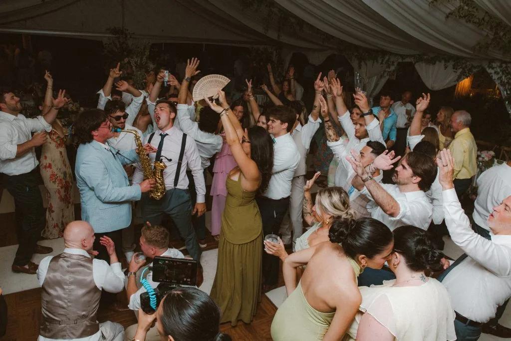 Packed wedding dance floor with guests dancing