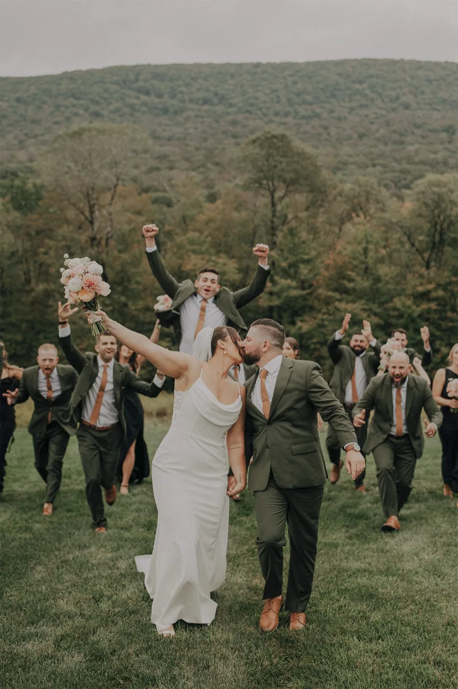 A newlywed couple celebrates with their wedding party outdoors after the ceremony, with a reception hosted by VARA DJs.