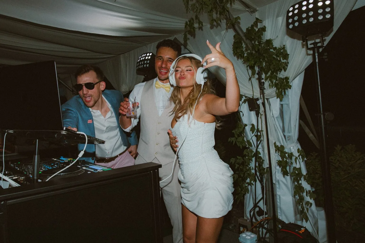 Wyatt DJing a wedding party with guests dancing at the booth