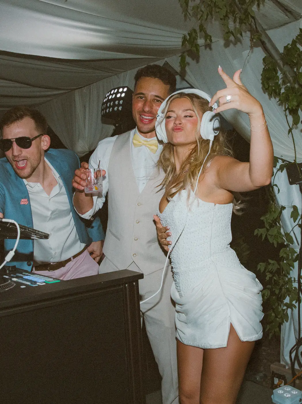 Newlyweds celebrating with their DJ at the DJ booth