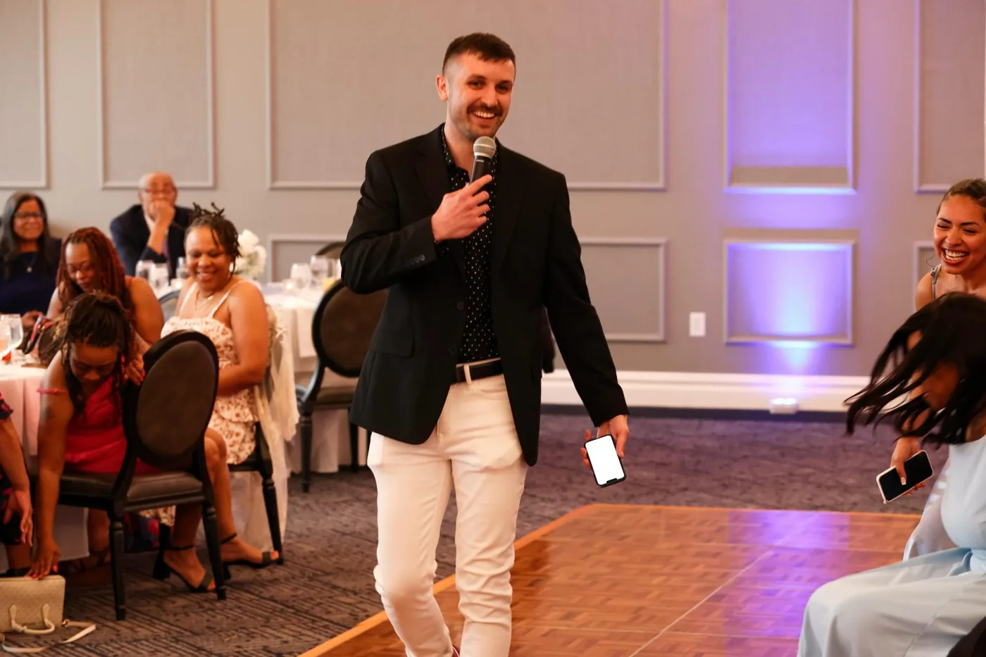 Scott emceeing a wedding reception in a ballroom
