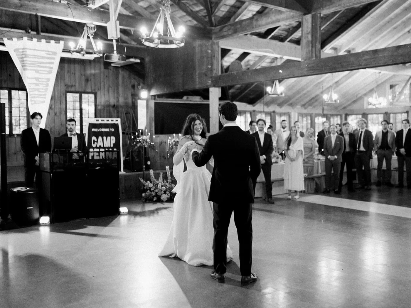 Couple's first dance at a barn wedding as guests watch