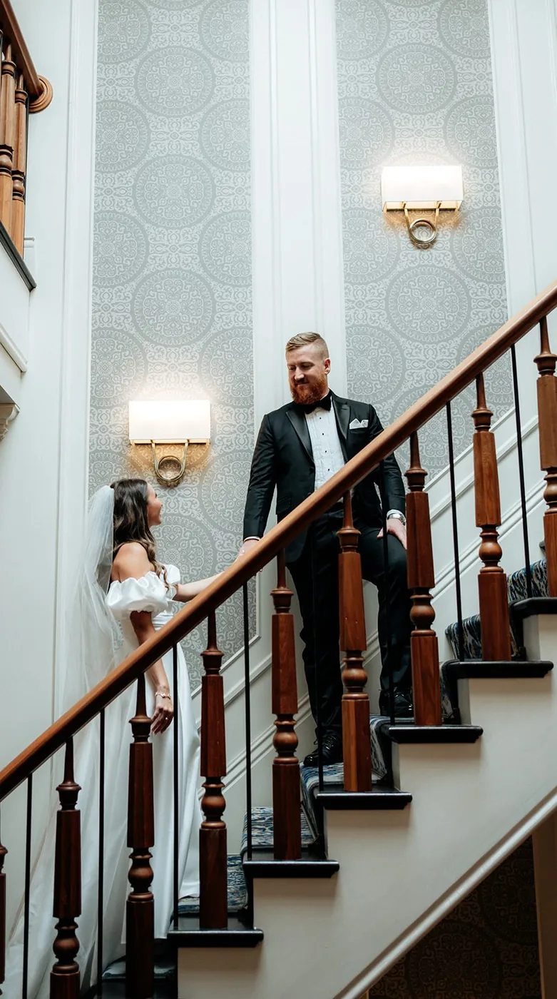 A newlywed couple walks together before their wedding reception at an Upstate New York venue, with VARA DJs.