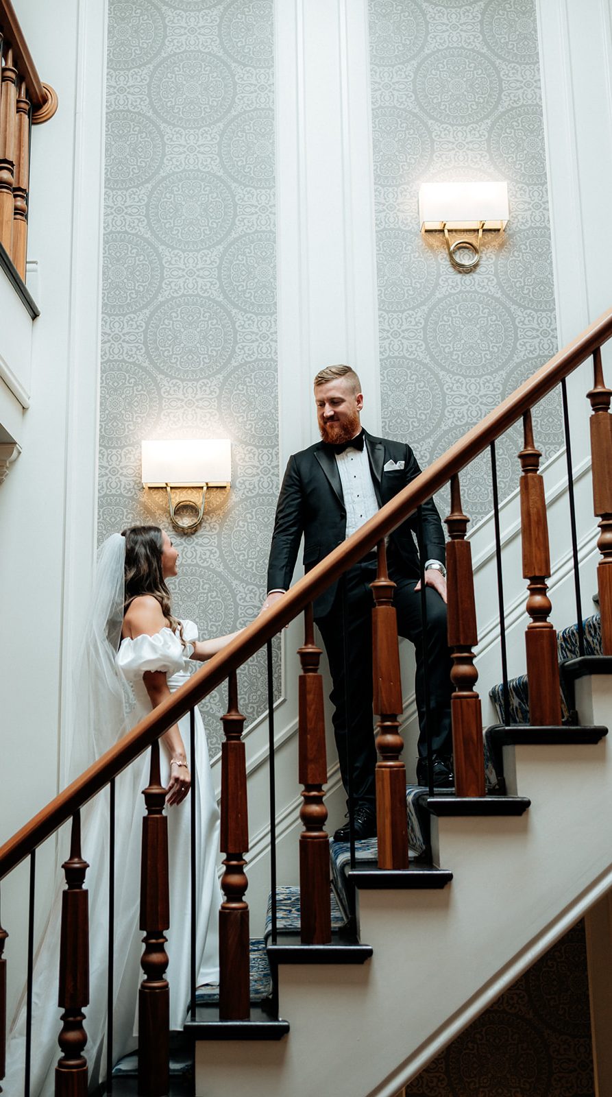 A newlywed couple walks together before their wedding reception at a beautiful Upstate New York venue, with entertainment by VARA DJs.